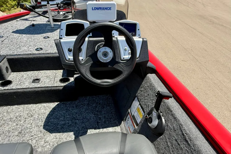Slide: The Image of 2026 Tracker Pro Team 195 boat cockpit with steering wheel and Lowrance electronics. - 14