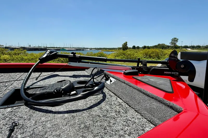Slide: The Image of 2026 Tracker Pro Team 195 boat with Minn Kota trolling motor, scenic lake view. - 23