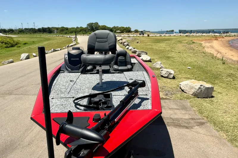 Slide: The Image of 2026 Tracker Pro Team 195 boat on a lakeside road, featuring a sleek red design. - 6