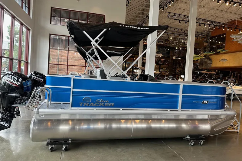 The Image of 2026 Sun Tracker Party Barge 18 DLX pontoon boat displayed indoors. - 0
