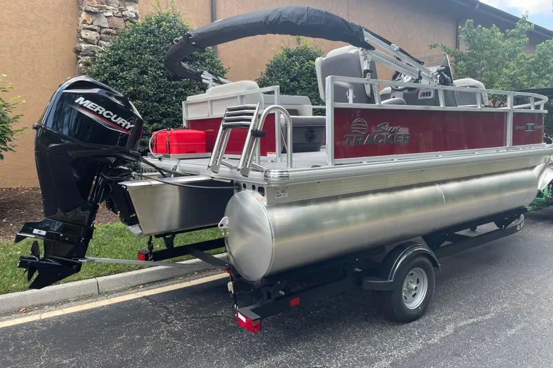 The Image of 2026 Sun Tracker Bass Buggy 16 XL Select pontoon boat with Mercury engine on trailer. - 0