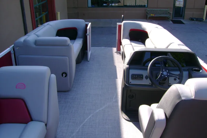 Slide: The Image of 2026 Sun Tracker Party Barge 20 DLX interior with plush seating and modern helm. - 6