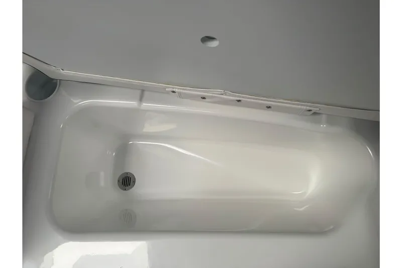 Slide: The Image of Interior view of a 2026 Tahoe T16 boat compartment with drain. - 12