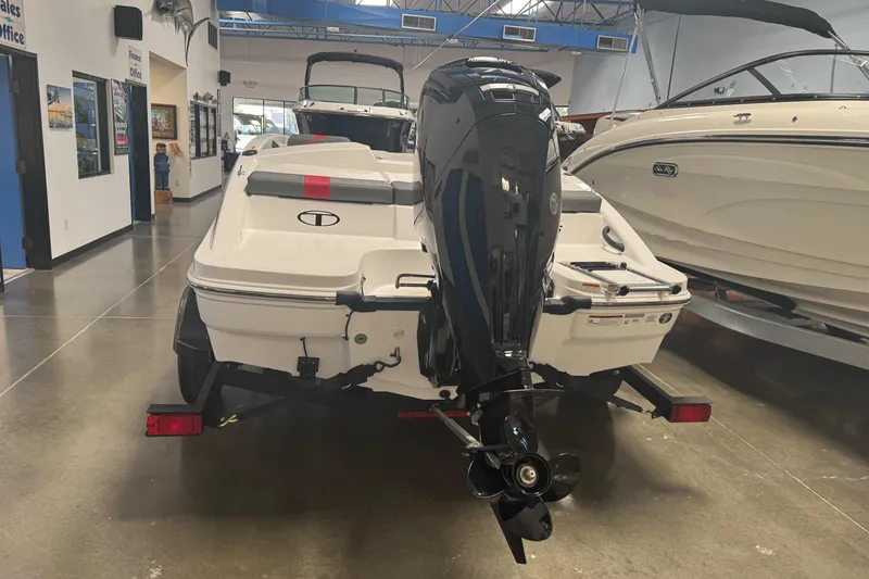 Slide: The Image of 2026 Tahoe T16 boat in showroom, featuring sleek design and powerful outboard motor. - 4