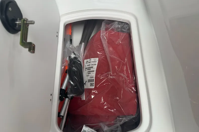 Slide: The Image of Storage compartment of 2026 Tahoe T16 boat with packaged accessories. - 5