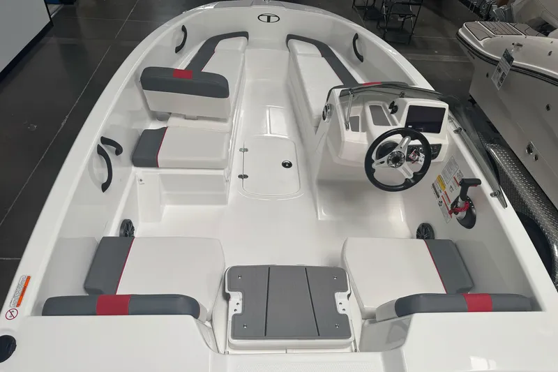 Slide: The Image of 2026 Tahoe T16 boat interior with modern seating and steering console. - 7