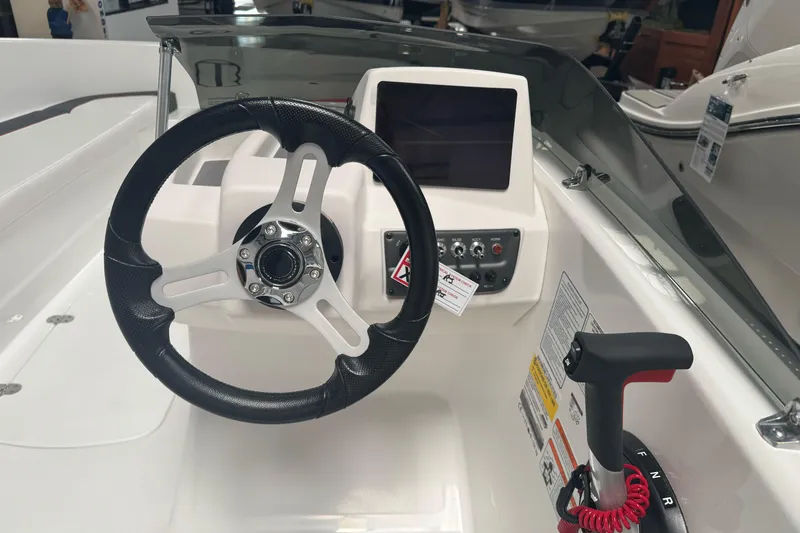 Slide: The Image of 2026 Tahoe T16 boat dashboard with steering wheel and control panel. - 8