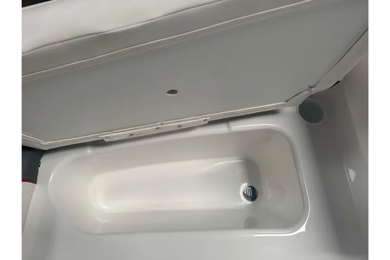 Slide: The Image of 2026 Tahoe T16 boat storage compartment with open lid, showcasing interior space. - 13