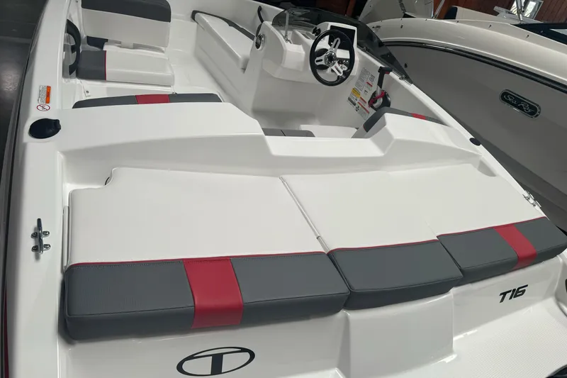 Slide: The Image of 2026 Tahoe T16 boat interior with white, gray, and red seating, steering wheel visible. - 6
