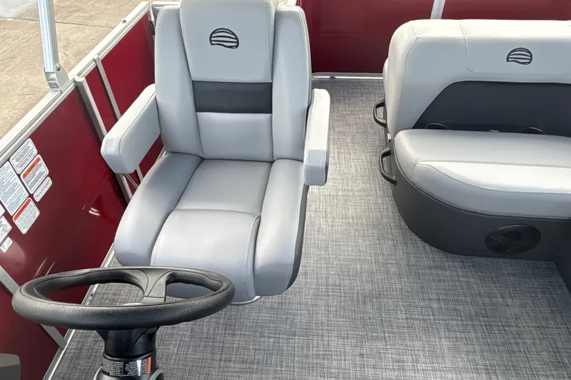 Slide: The Image of Interior of 2026 Sun Tracker Party Barge 18 DLX with gray seating and steering wheel. - 14