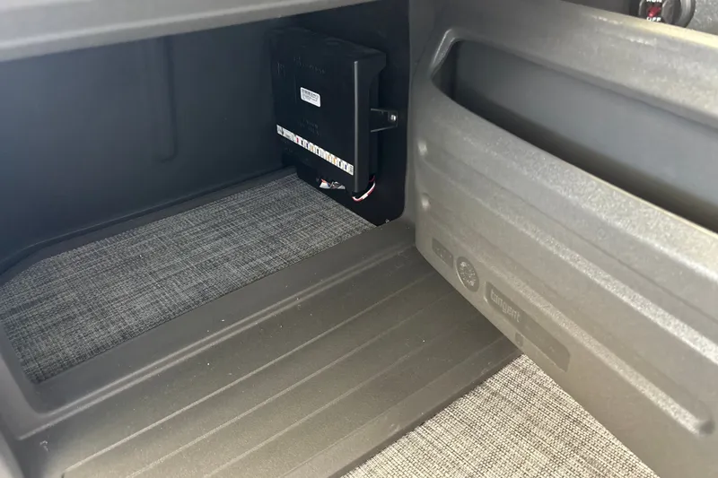 Slide: The Image of Interior storage compartment of 2026 Sun Tracker Party Barge 18 DLX with electrical components. - 33