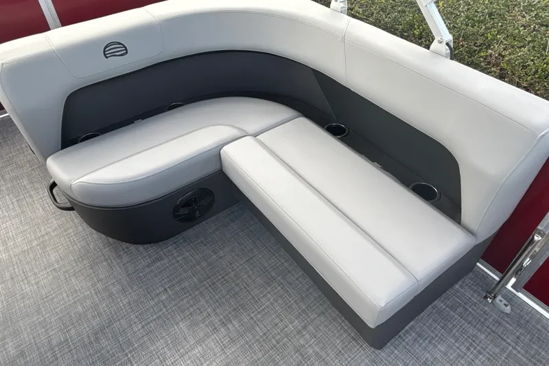 Slide: The Image of 2026 Sun Tracker Party Barge 18 DLX interior seating with cup holders and modern design. - 13
