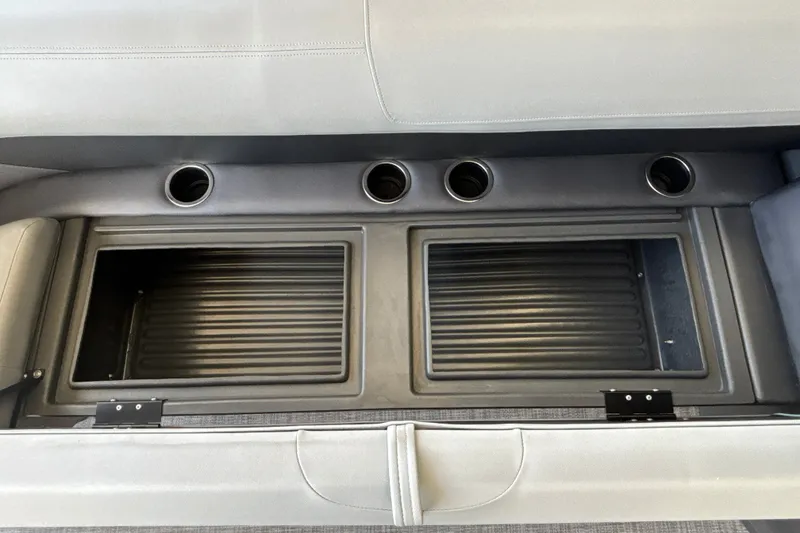 Slide: The Image of 2026 Sun Tracker Party Barge 18 DLX seating with integrated cup holders and storage compartments. - 27