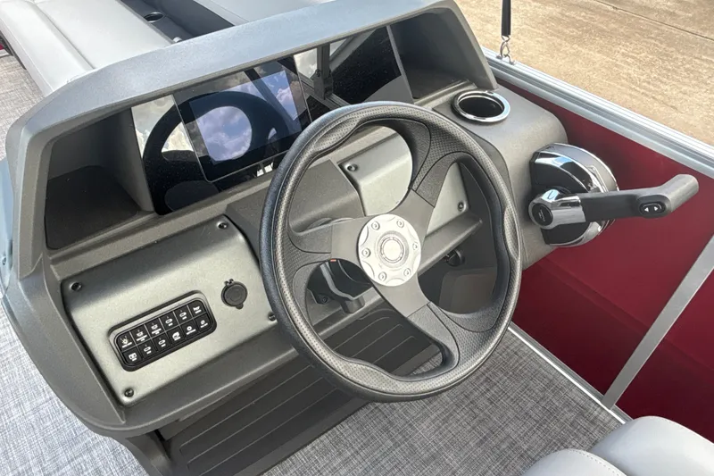 Slide: The Image of 2026 Sun Tracker Party Barge 18 DLX steering console with modern controls and dashboard. - 23