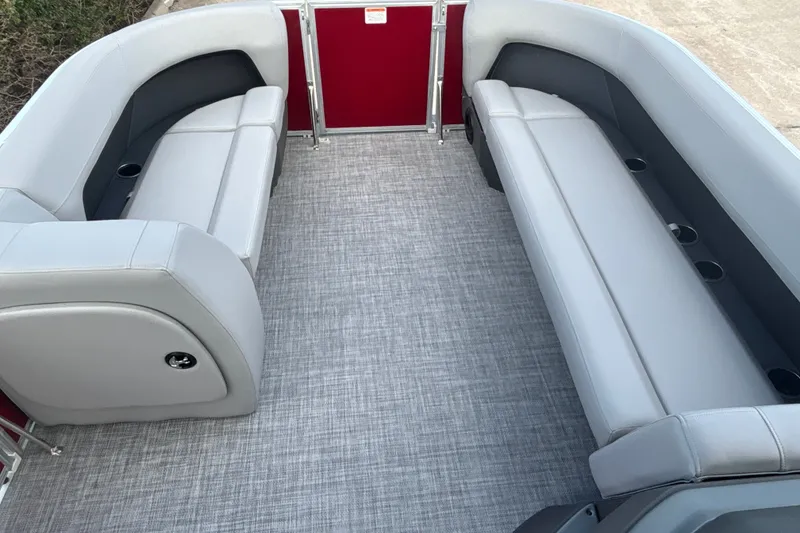 Slide: The Image of 2026 Sun Tracker Party Barge 18 DLX interior with gray seating and red accents. - 15