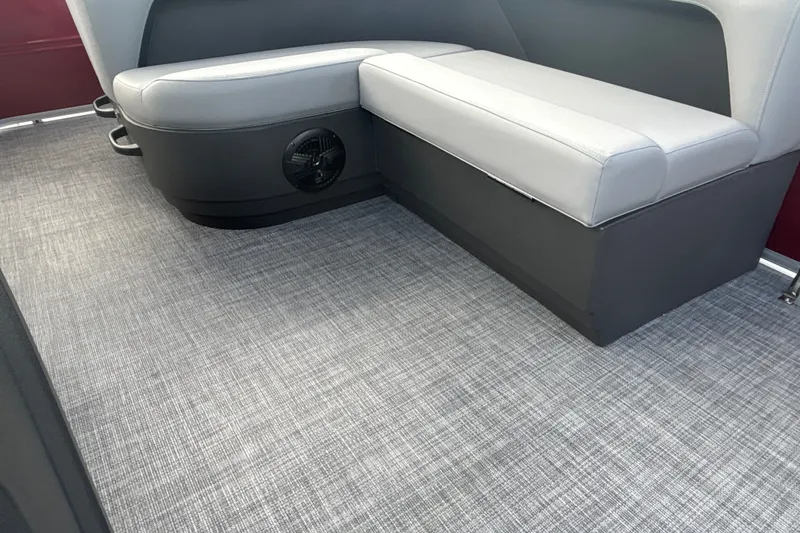 Slide: The Image of 2026 Sun Tracker Party Barge 18 DLX interior with gray seating and textured flooring. - 18