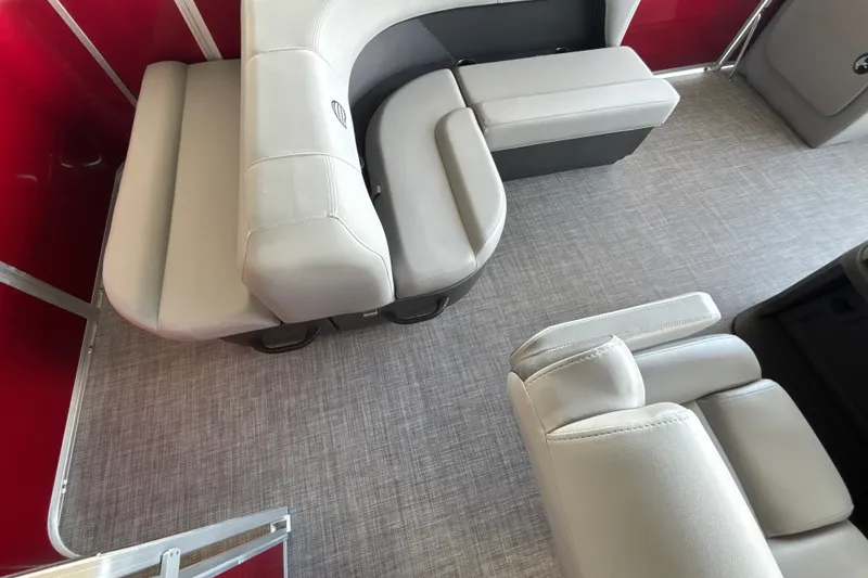 Slide: The Image of 2026 Sun Tracker Party Barge 18 DLX interior with gray seating and red accents. - 20