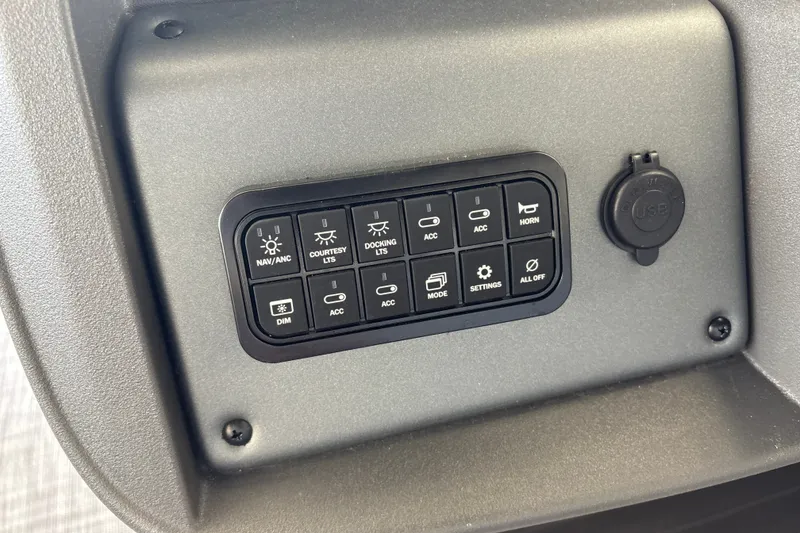 Slide: The Image of Control panel of 2026 Sun Tracker Party Barge 18 DLX with various switches and USB port. - 25