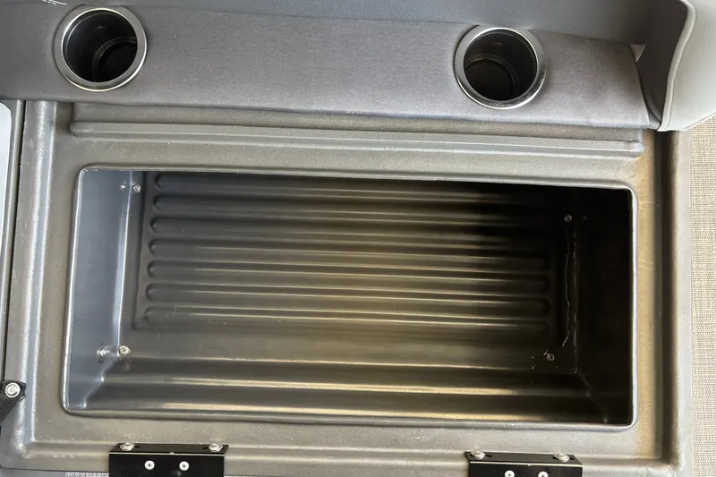 Slide: The Image of Storage compartment of 2026 Sun Tracker Party Barge 18 DLX with cup holders. - 30