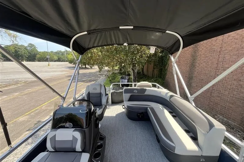 Slide: The Image of 2026 Sun Tracker Bass Buggy 18 DLX pontoon boat interior with seating and canopy. - 13