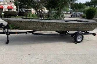 The Image of 2026 Tracker Grizzly 1648 Utility boat on trailer, parked outdoors. - 0