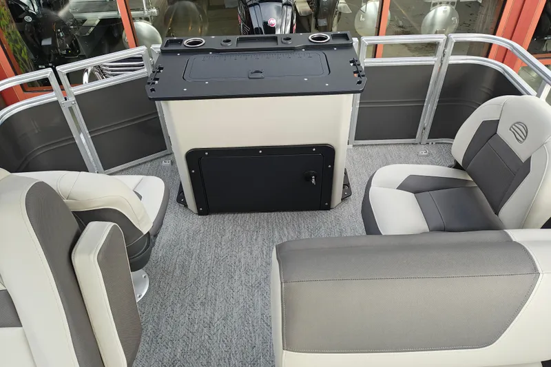 Slide: The Image of 2026 Sun Tracker Fishin' Barge 20 DLX interior with comfortable seating and fishing station. - 17