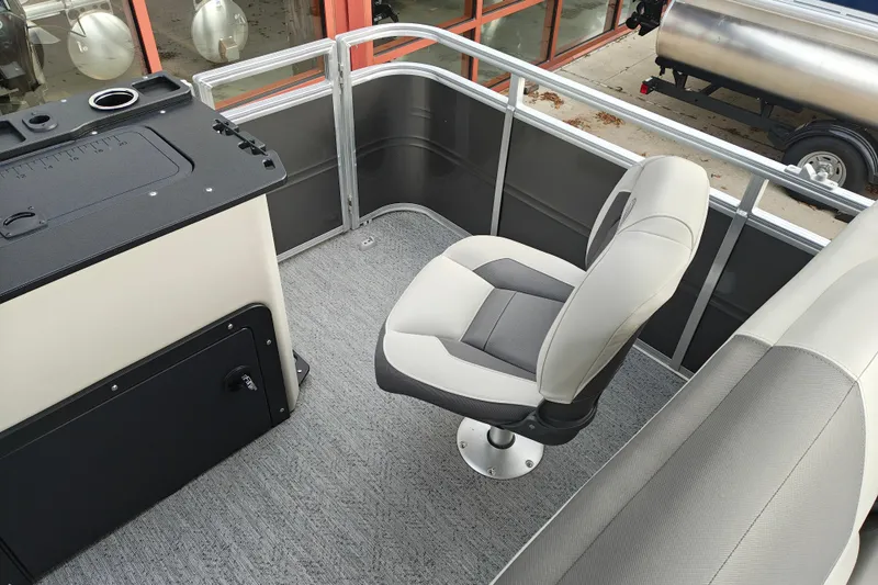 Slide: The Image of 2026 Sun Tracker Fishin' Barge 20 DLX interior with seating and control panel. - 18