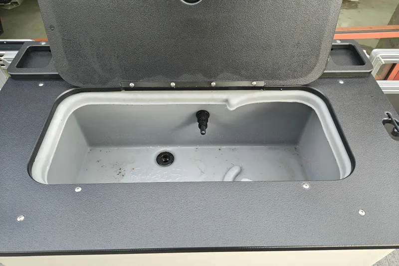 Slide: The Image of Open storage compartment on 2026 Sun Tracker Fishin' Barge 20 DLX boat. - 21