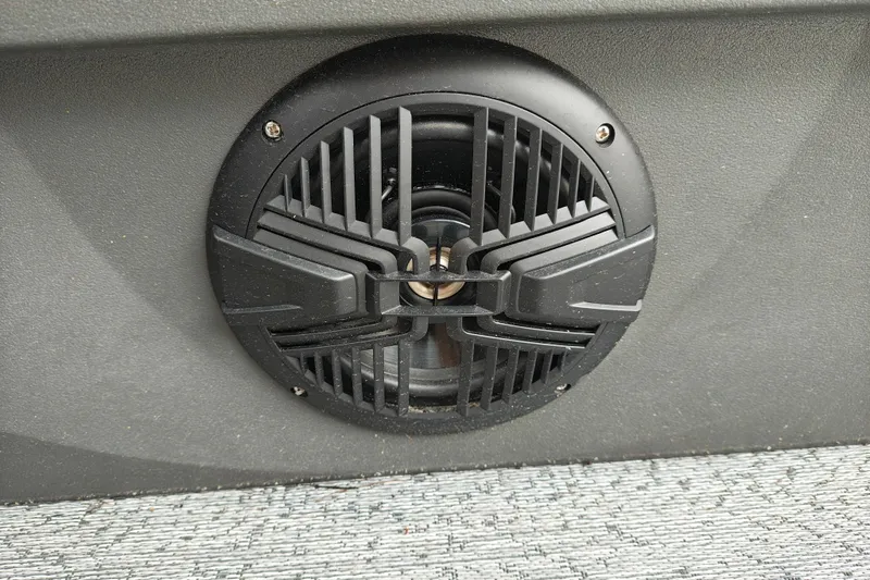 Slide: The Image of Speaker on 2026 Sun Tracker Fishin' Barge 20 DLX boat, featuring sleek black grille design. - 16