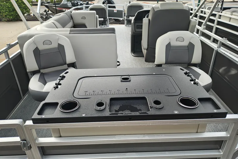 Slide: The Image of 2026 Sun Tracker Fishin' Barge 20 DLX interior with seating and fishing station. - 26