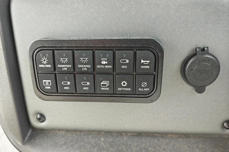 Slide: The Image of Control panel of 2026 Sun Tracker Fishin' Barge 20 DLX with various switches and USB port. - 30