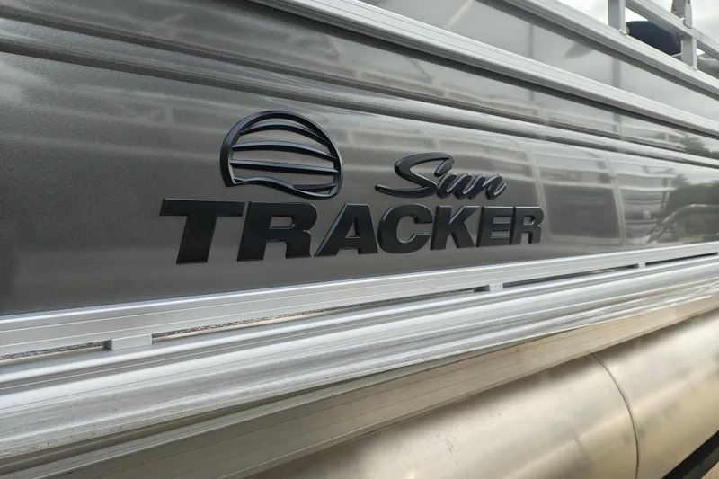 Slide: The Image of 2026 Sun Tracker Fishin' Barge 20 DLX logo on sleek metallic surface. - 7