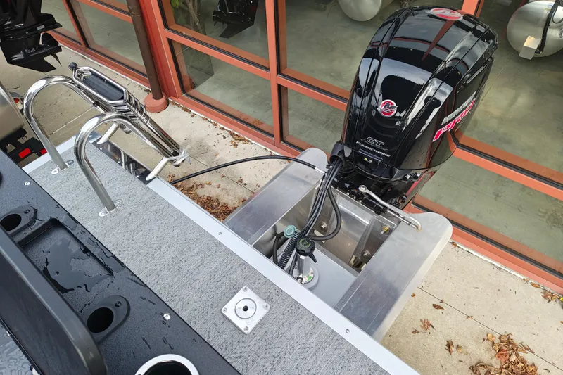 Slide: The Image of 2026 Sun Tracker Fishin' Barge 20 DLX with powerful outboard motor and sturdy ladder. - 24