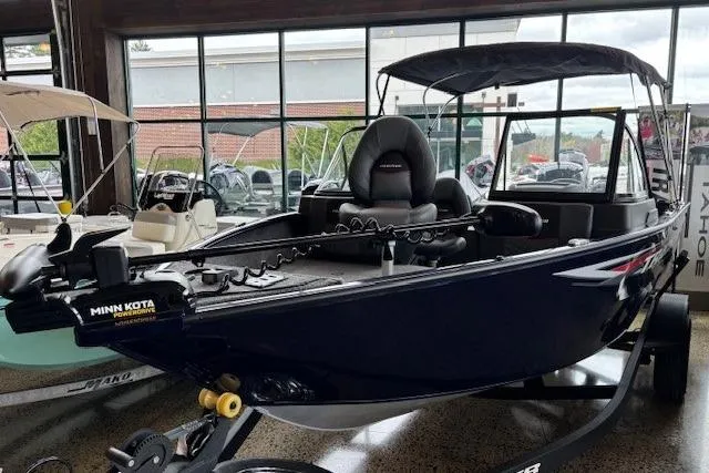 Slide: The Image of 2026 Tracker Pro Guide V-175 Combo boat with Minn Kota trolling motor in showroom. - 2