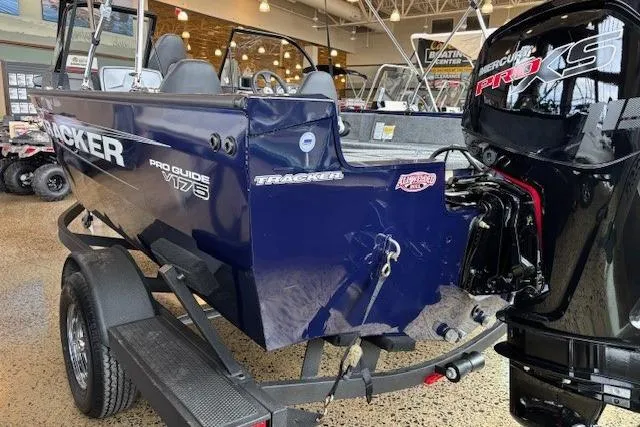 Slide: The Image of 2026 Tracker Pro Guide V-175 Combo boat with Mercury Pro XS engine in showroom. - 4