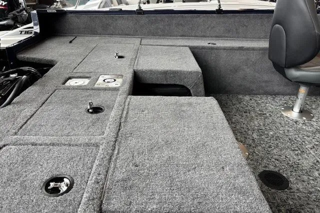 Slide: The Image of 2026 Tracker Pro Guide V-175 Combo boat interior with gray carpeted deck and seating. - 7