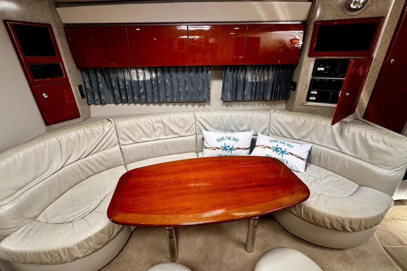Slide: The Image of Luxurious interior of a 2006 Formula 40 Performance Cruiser with plush seating and wooden table. - 12