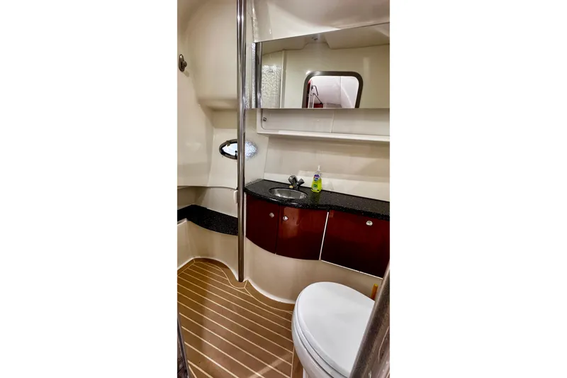 Slide: The Image of Bathroom interior of 2006 Formula 40 Performance Cruiser with modern fixtures and wood accents. - 15