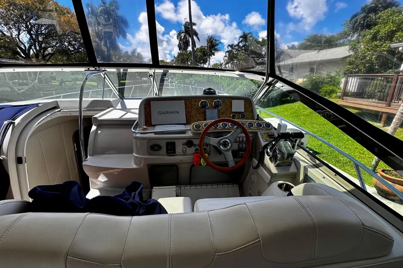 Slide: The Image of 2006 Formula 40 Performance Cruiser cockpit with Garmin navigation, lush greenery outside. - 4