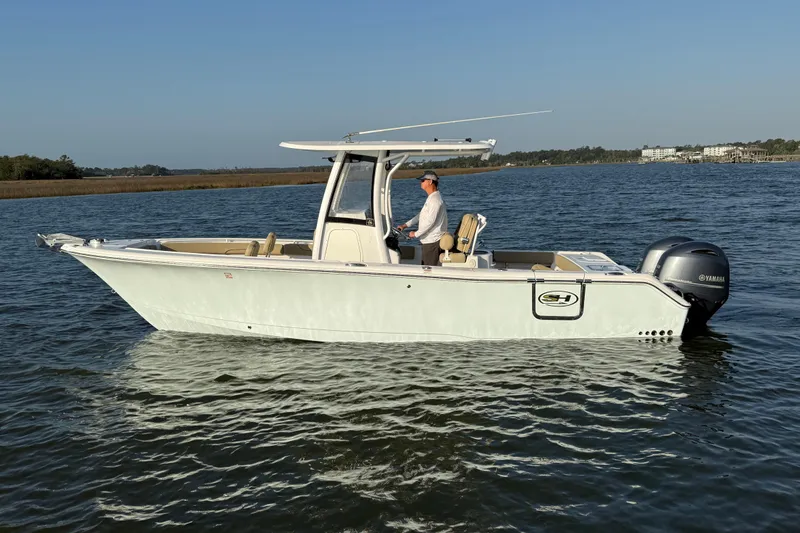 The Image of 2017 Sea Hunt Gamefish 25 boat on water, featuring Yamaha outboard engine. - 0