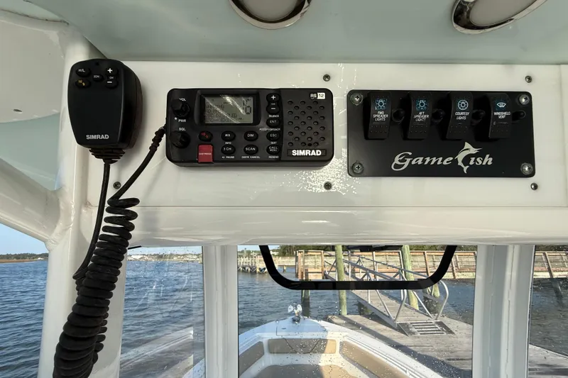 Slide: The Image of 2017 Sea Hunt Gamefish 25 boat dashboard with Simrad radio and control panel. - 15