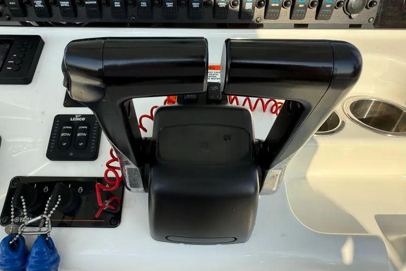 Slide: The Image of Control panel of a 2017 Sea Hunt Gamefish 25 boat with throttle levers and switches. - 19