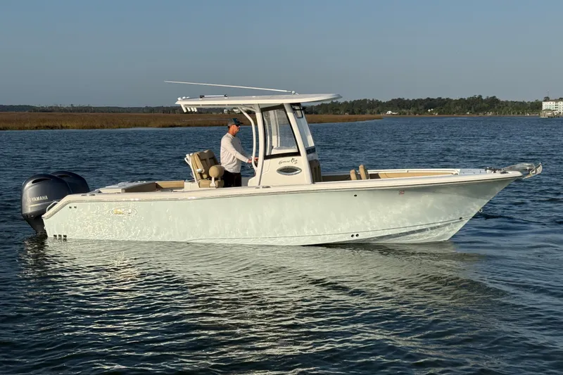 Slide: The Image of 2017 Sea Hunt Gamefish 25 boat cruising on calm waters with Yamaha engine. - 2