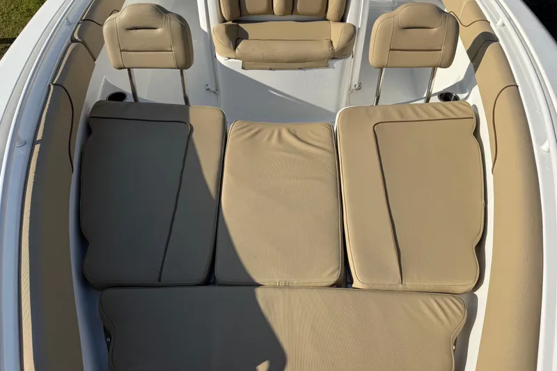 Slide: The Image of 2017 Sea Hunt Gamefish 25 boat interior with beige cushioned seating. - 29