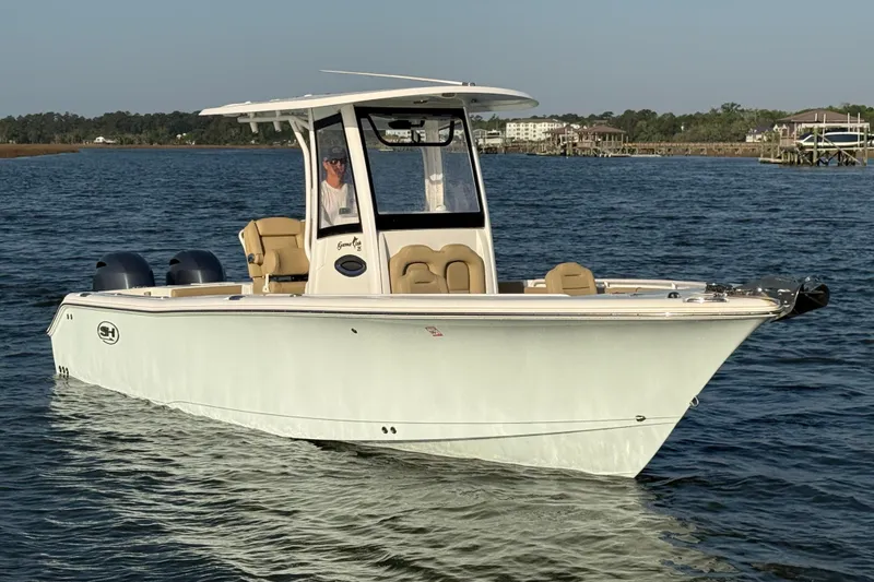 Slide: The Image of 2017 Sea Hunt Gamefish 25 boat cruising on calm waters. - 3