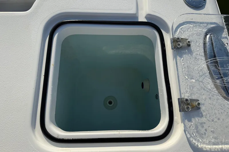 Slide: The Image of Open livewell on 2017 Sea Hunt Gamefish 25 boat, showing interior and lid details. - 33