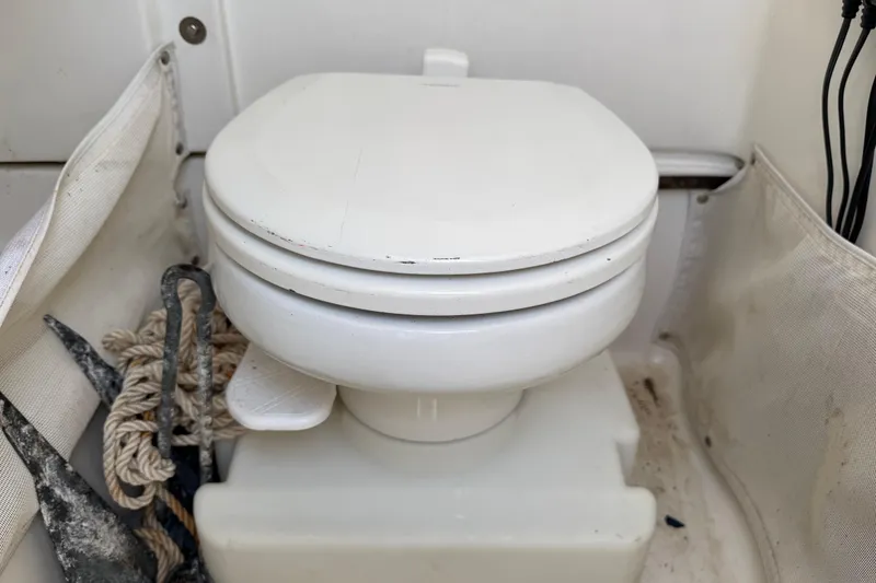 Slide: The Image of Boat toilet on a 2017 Sea Hunt Gamefish 25, with anchor and rope nearby. - 36