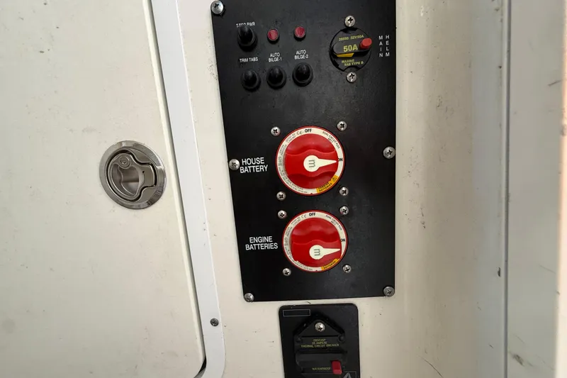 Slide: The Image of Control panel of a 2017 Sea Hunt Gamefish 25 boat, featuring battery switches and circuit breakers. - 38