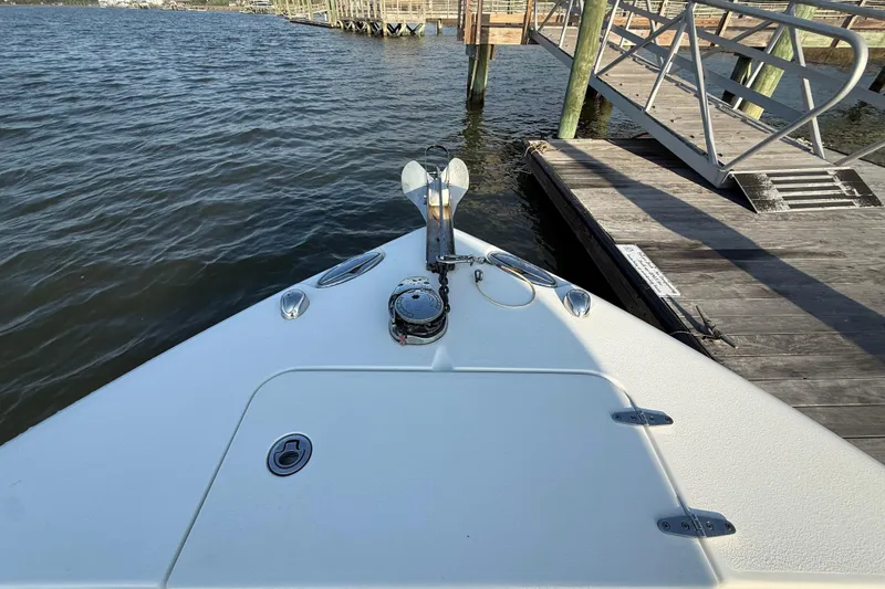 Slide: The Image of Bow of 2017 Sea Hunt Gamefish 25 at dock, featuring anchor and calm waters. - 39