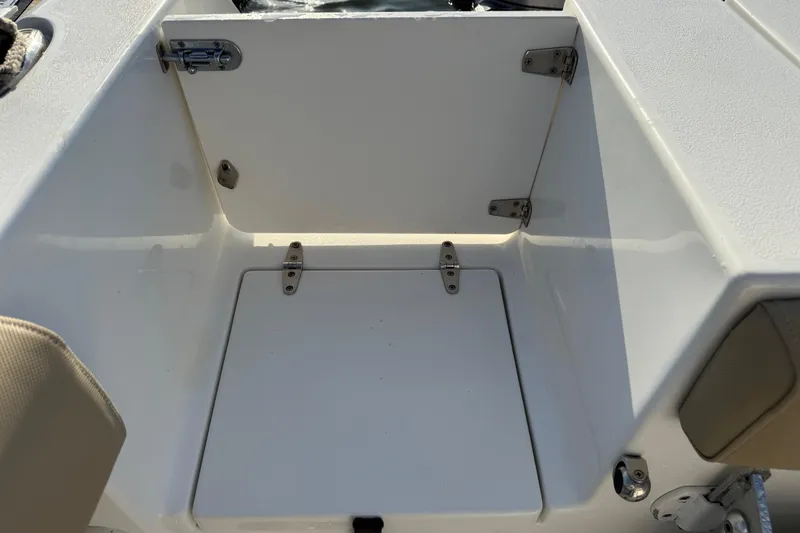 Slide: The Image of 2017 Sea Hunt Gamefish 25 boat storage compartment with open hatch, showcasing interior space. - 40